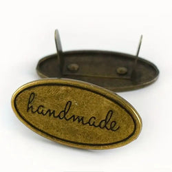 HARDWARE ACCESSORY: Set of 3 Oval (approx 1½" long) "Handmade" Metal Brad Plaques in antique colour